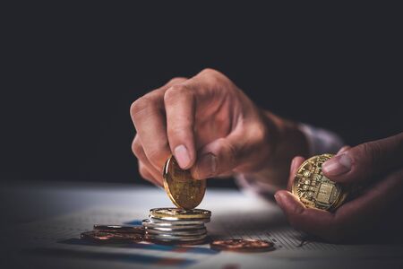 Bit coin in the business man hand;  Digitall symbol of a new virtual currencyの写真素材