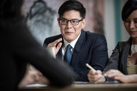 Job interview, businessman listen to candidate answers.の写真素材