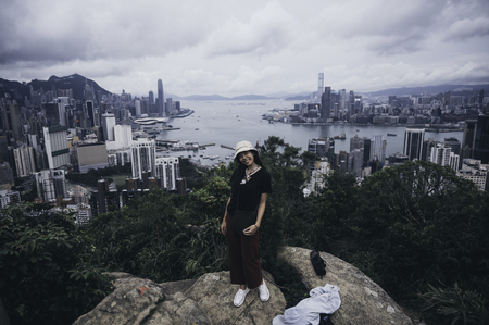 Younger women traveler standing at the top of mountain with city viewのeditorial素材