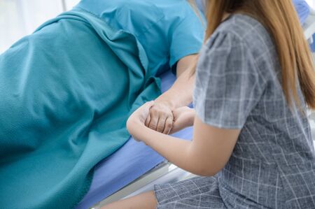 Unrecognizable health visitor and a senior woman during home visの写真素材