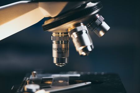 Close-up shot of microscope with metal lens at laboratory.の写真素材