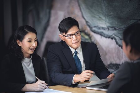 Human resources manager conducting job interview with applicants in officeの写真素材