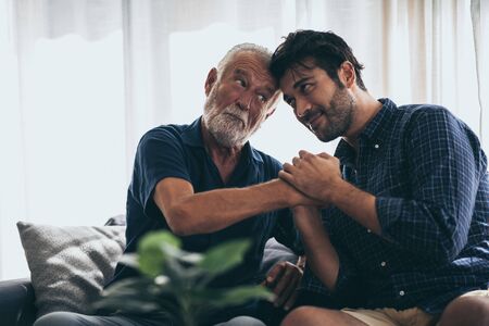 Hipster son with his senior father at home.