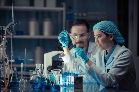 In a Modern Laboratory Scientists team Conduct Experiments, Consisting of glassware  test tubes and...