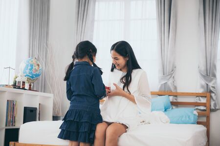 The daughter gave the mother a gift on Valentine's Day.の写真素材