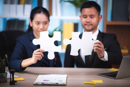 Business solutions, success and strategy concept. Businessman hand connecting jigsaw puzzle.の写真素材