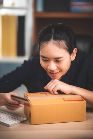 Young business woman working online shopping at her homeの写真素材