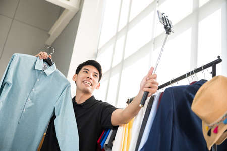 business startup, young man selling product from home, online marketing