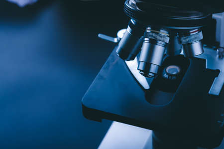 Laboratory equipment optical microscope, closeup of scientific microscope with metal lens, data...