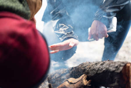 campfire winter night in the forest, fire baking and warm cozy conceptの写真素材