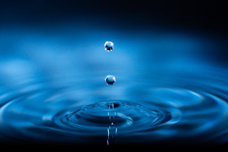 abstract background of blue water splash falling drop on liquid wave