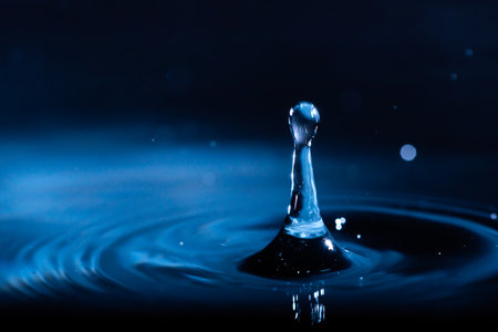 abstract background of blue water splash falling drop on liquid wave