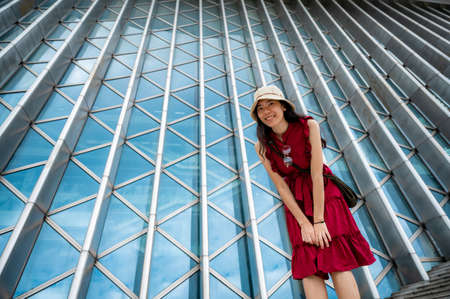 Asian woman in red dress at modern building, female girl with urban city lifestyle