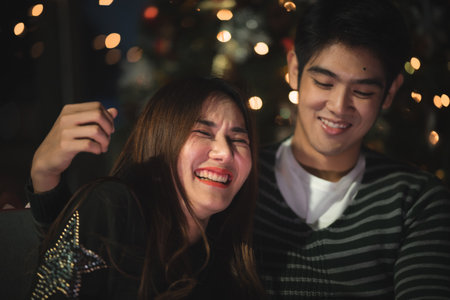 Asian lover celebrate and enjoy together for Chirstmas and happy new year festival at home romance concept.の写真素材