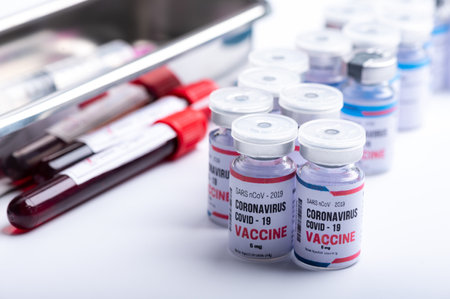 virus vaccine development of a coronavirus COVID-19, vaccine bottle in concept of insurance and...