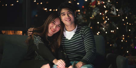 Asian lover celebrate and enjoy together for Chirstmas and happy new year festival at home romance...