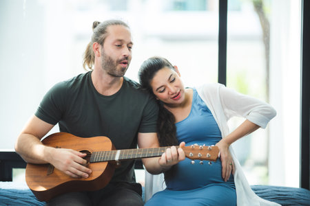 pregnant woman with her husband couple at home, family person pregnancy motherhood conceptの写真素材