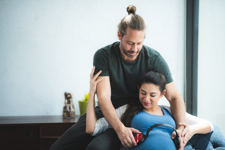 pregnant woman with her husband couple at home, family person pregnancy motherhood concept