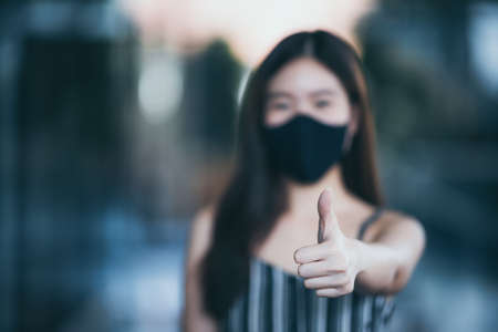 young Asian woman wearing surgical face mask for health protection, disease virus flu epidemicの写真素材