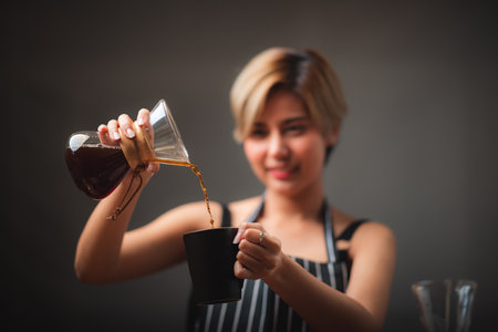 Asian barista girl making coffee, fresh coffee pouring filter drip toolの写真素材