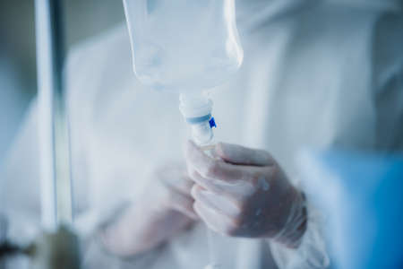 professional doctor and nurse are wearing PPE suit protection and looking for coronavirus covid-19 virus infected patient's in hospital laboratoryの写真素材
