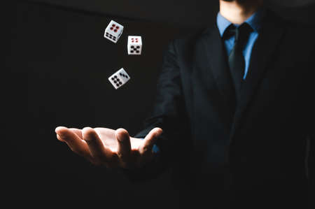 business person hand throw the dice, business gambling game conceptの写真素材