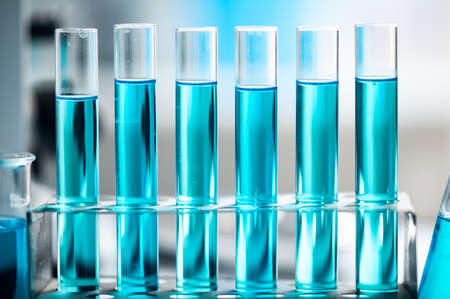 Chemistry laboratory glassware, science laboratory research and development concept, flask, beaker, and test tubes with blue liquid water sample test, scientific test tubes equipmentの写真素材