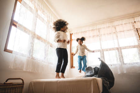 African American children  girl having fun to play with her sister, childhood family at home conceptの写真素材
