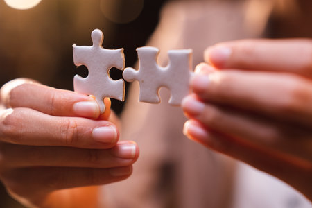 Business person team work holding jigsaw to connecting successful puzzle piece for matching to goals target, success and start up new project in business marketing plan conceptの写真素材