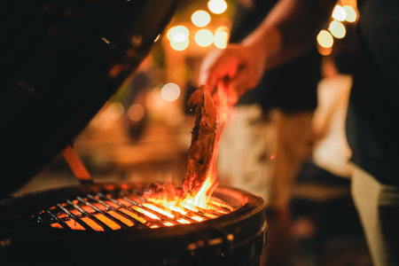 Asian people Enjoying Summer BBQ Party, Cooking Delicious Meat Grill for Friends, Sharing Fun and Happy Moments Together, Embracing a Lifestyle of Friendship Dinner at Nightの写真素材