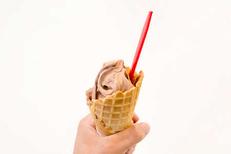 hand catch Ice cream cone chocolate Brownies White backgroundの写真素材