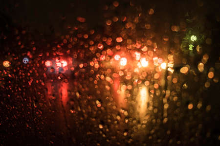 beautiful drops of water on a glass street light at night.