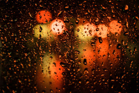 beautiful drops of water on a glass street light at night.
