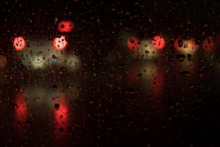 beautiful drops of water on a glass street light at night.