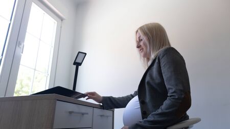 pregnant working in an officeの写真素材