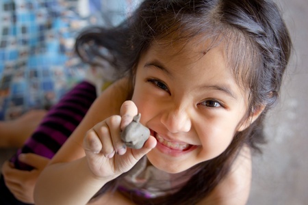 Little girl playing with clayの写真素材