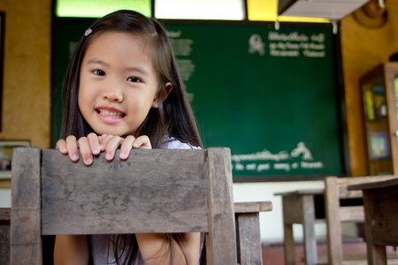 Smiley asian girl in the classroomの写真素材