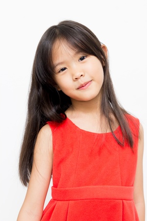 Little Asian girl in beautiful red dressの写真素材