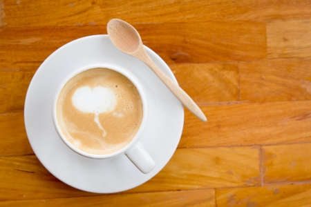 A cup of coffee on wooden background の写真素材