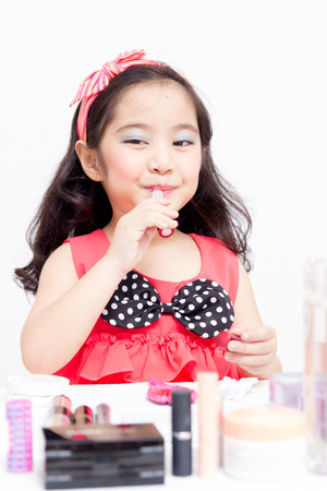 Little Asian child playing with mothers makeupの写真素材