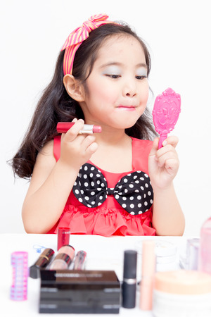 Little Asian child playing with mothers makeupの写真素材