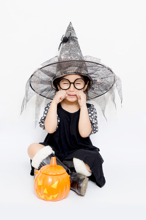 Surprise Happy witch child with pumpkin in Halloween dressの写真素材