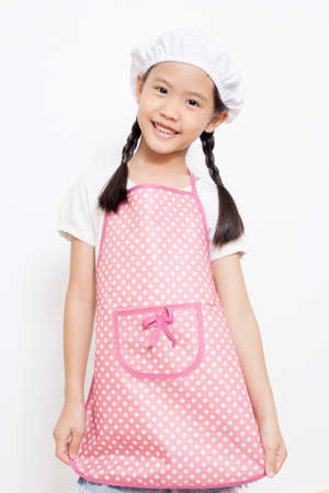 Little Asian cute chef wearing pink apronの写真素材