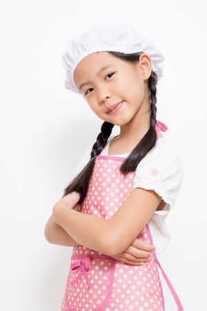 Little Asian cute chef wearing pink apronの写真素材