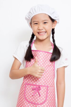 Pretty Asian cute chef wearing pink apron and thumb upの写真素材