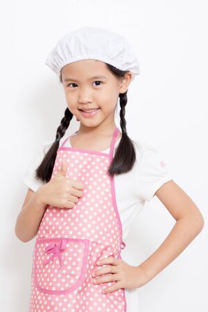 Pretty Asian cute chef wearing pink apron and thumb upの写真素材