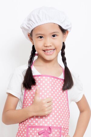 Pretty Asian cute chef wearing pink apron and thumb upの写真素材