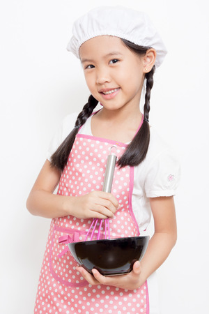 Little Asian cute chef wearing pink apronの写真素材