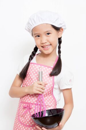 Little Asian cute chef wearing pink apronの写真素材