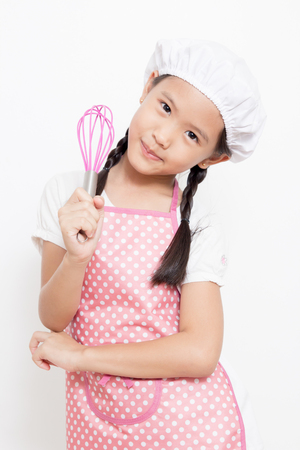 Little Asian cute chef wearing pink apronの写真素材
